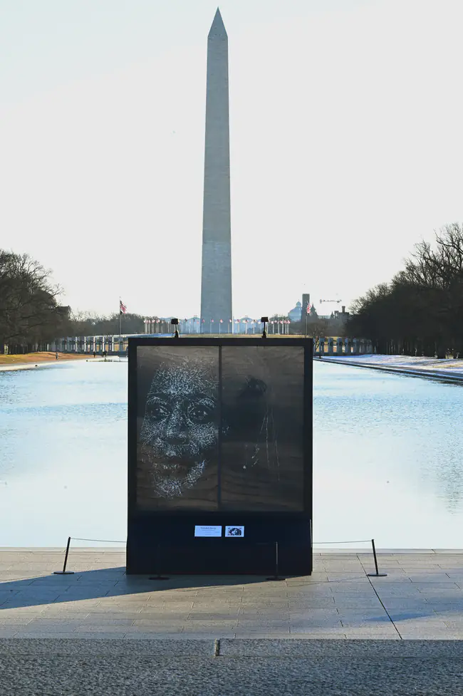 A portrait drawn in shattered glass, installed before the Washington Monument